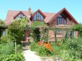 view of Gardeners Rest and pergola from the vegetable garden